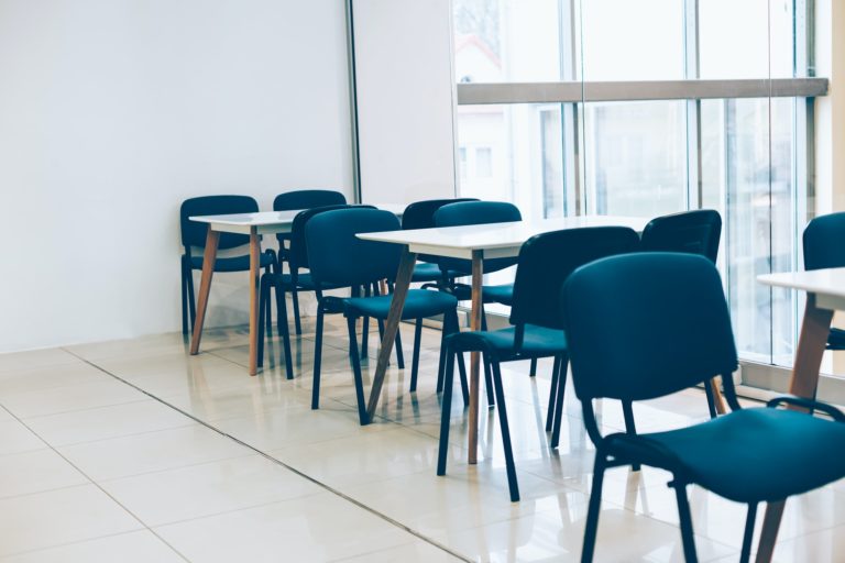 Coworking room space with tables and chairs