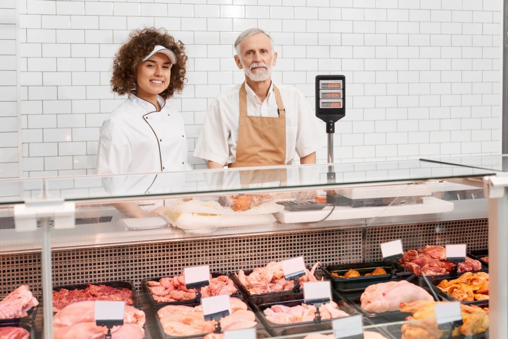 Shop workers posing behind counter